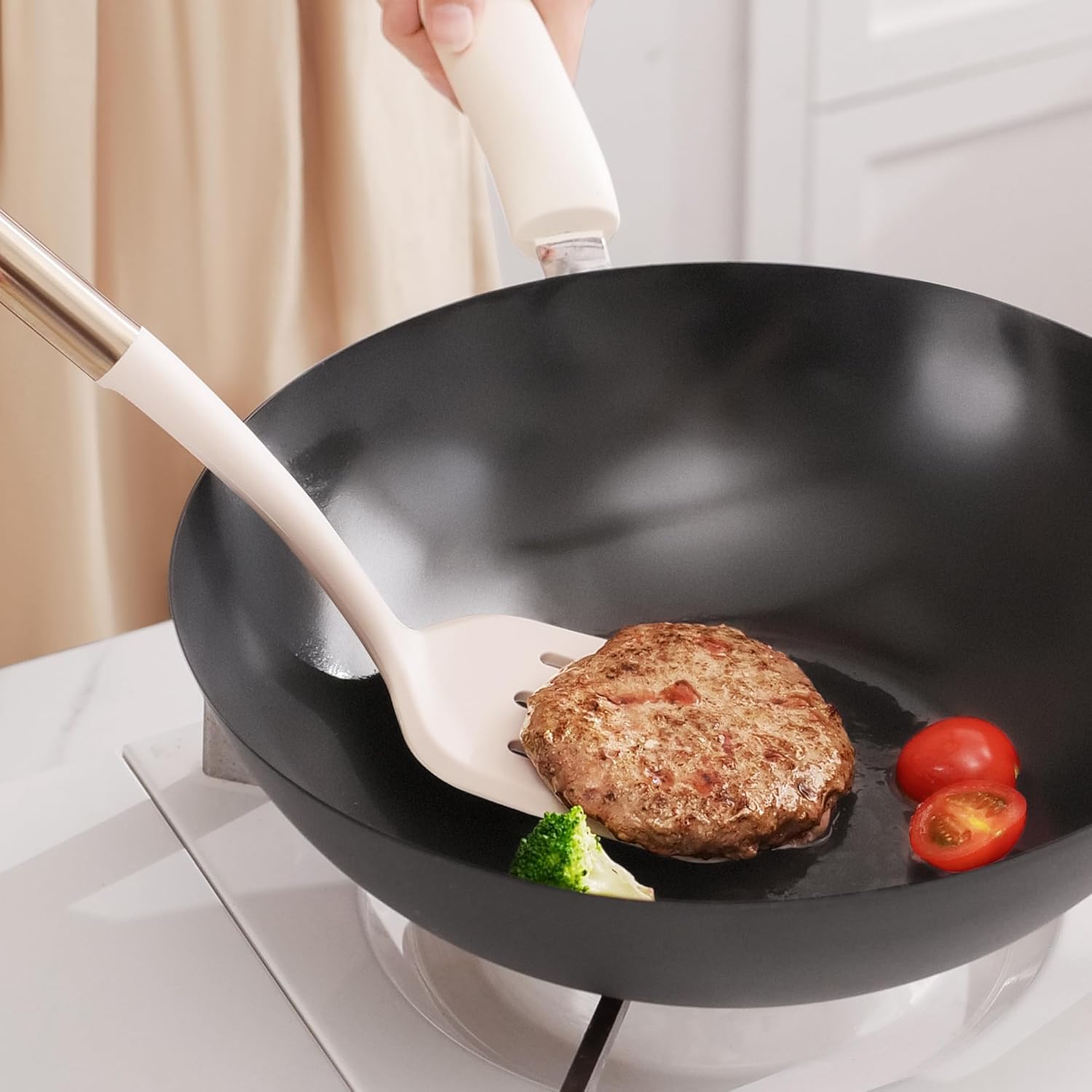 An OOU spatula flipping a perfectly cooked patty in a frying pan, ideal for creating delicious recipes.